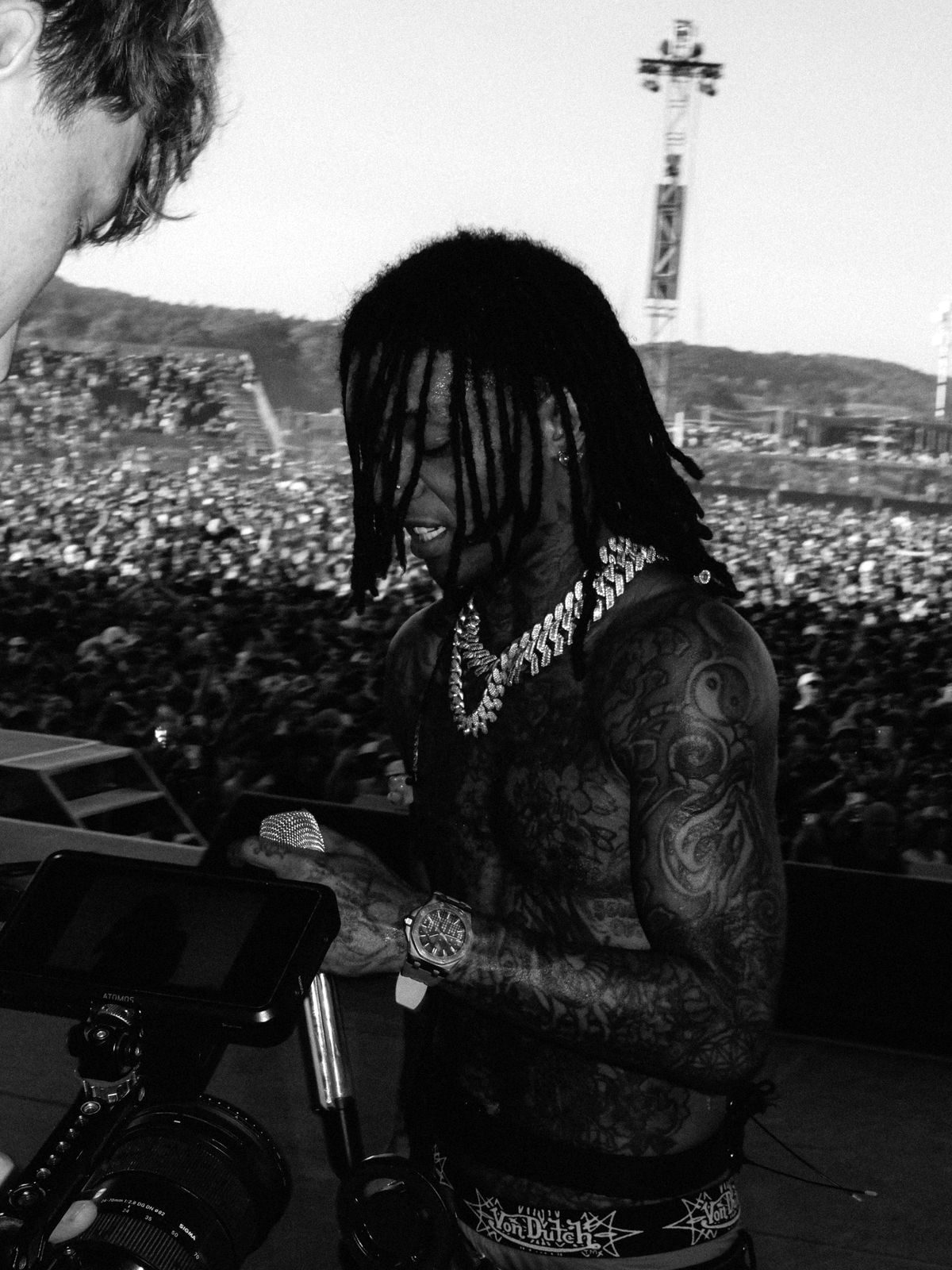 Swae Lee on stage in front of a festival crowd, next to Oliver's camera monitor