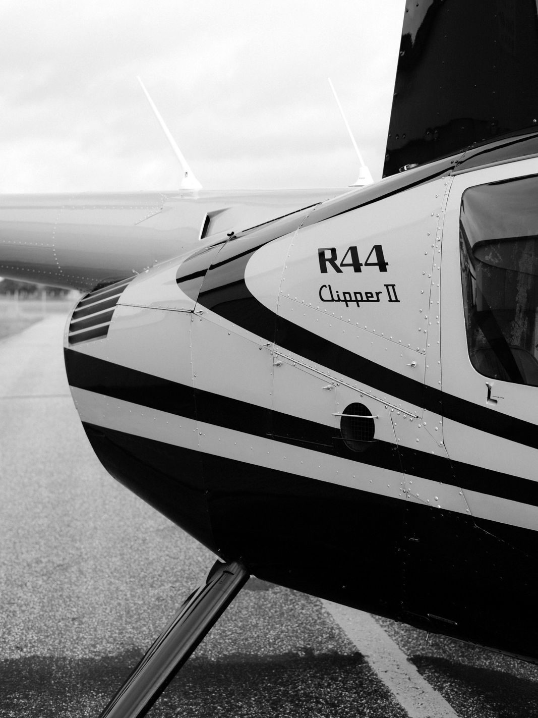 Close-up of an R44 helicopter on a runway